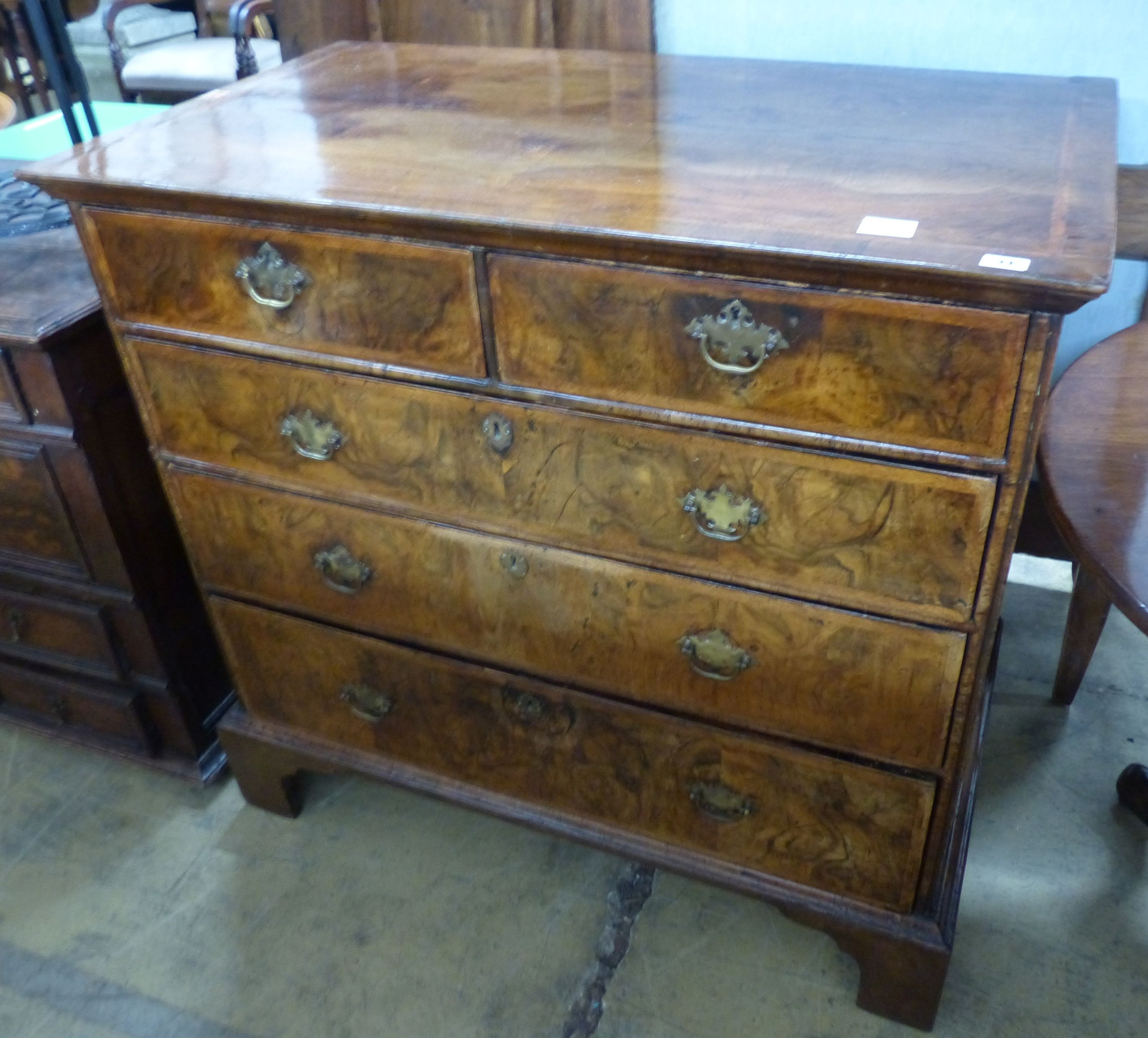 An 18th century crossbanded walnut chest of two short and three graduated long drawers, on bracket feet, W.99cm D.58cm H.94cm